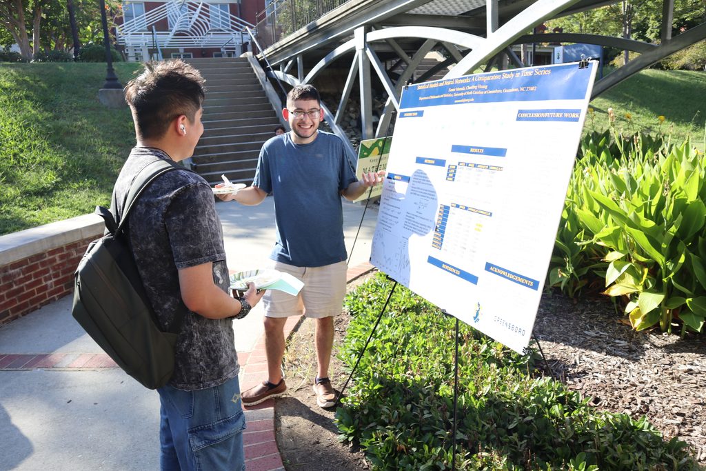 pictures of students and faculty talking around display of student research posters